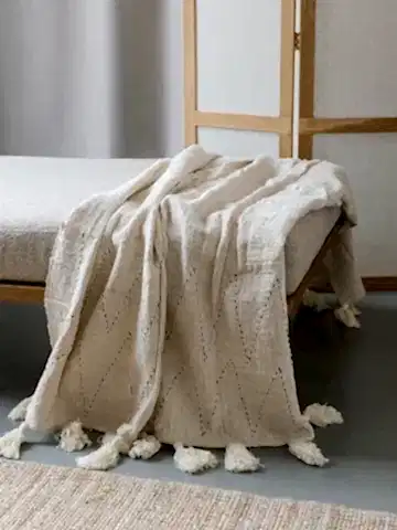 HAND STITCHED COVER WITH WHITE TASSELS